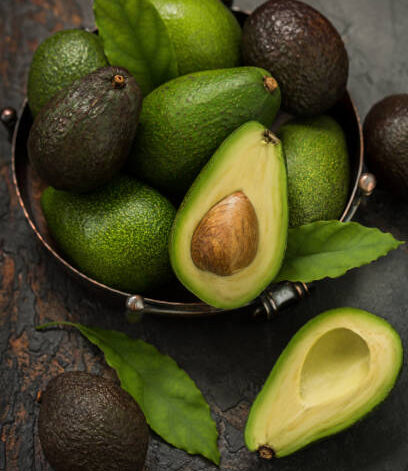 Fresh avocados in a vintage dish on the table.